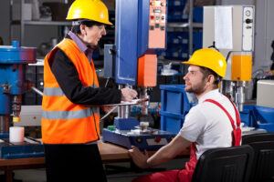 Workers compare hats Herschel Systems Limited